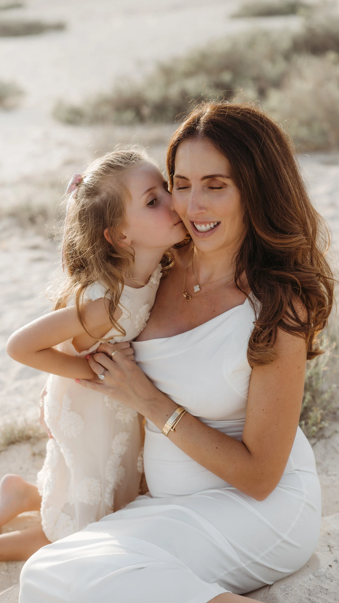 Dubai Family Photographer Beach Sitting Motherhood Embrace Unposed Laughing